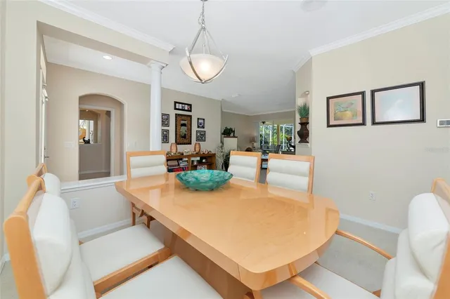 a dining room with furniture a chandelier and fireplace