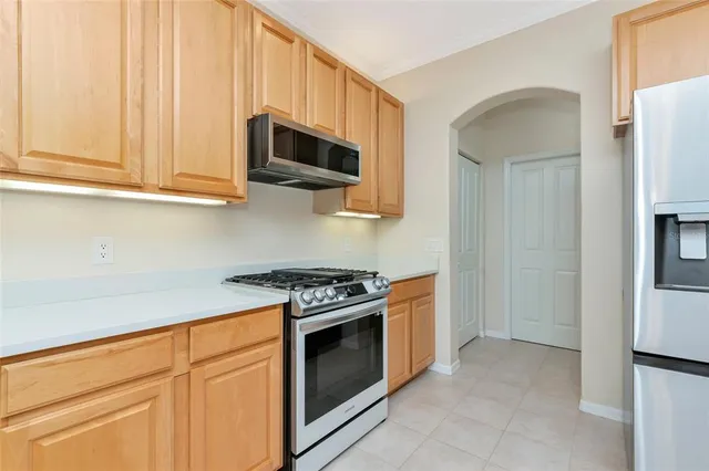 a spacious bathroom with double vanity a toilet a sink and a mirror
