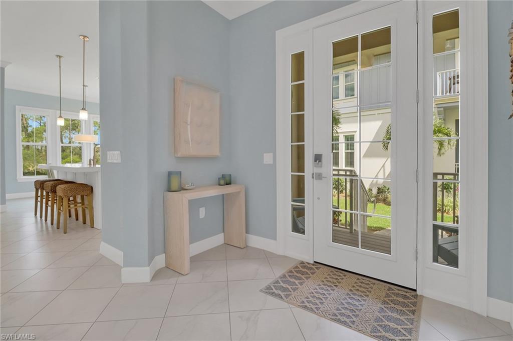6509 Dominica Drive, Unit 101 Naples, FL 34113 - Photo 6 of 33 a view of a hallway with windows and chandelier