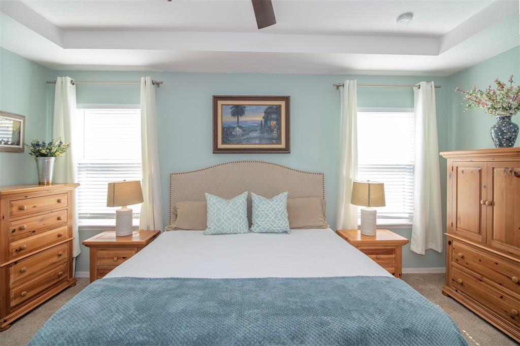 1111 Spruce Ridge Court Minneola, FL 34715 - Photo 15 of 34 a bedroom with a bed and wooden floor