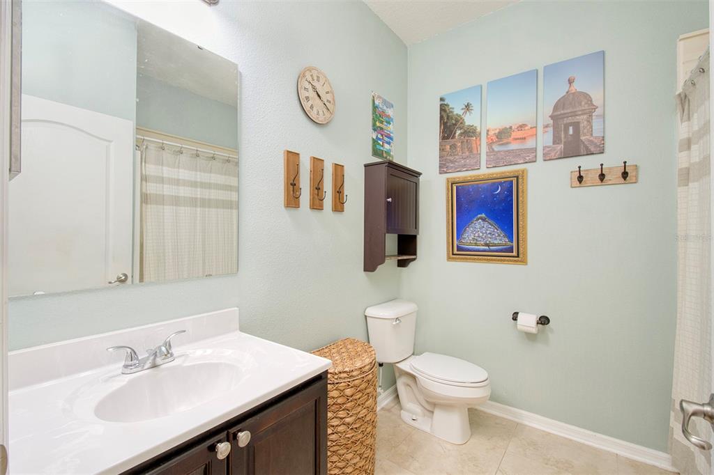 1111 Spruce Ridge Court Minneola, FL 34715 - Photo 20 of 34 a bathroom with a toilet sink and mirror