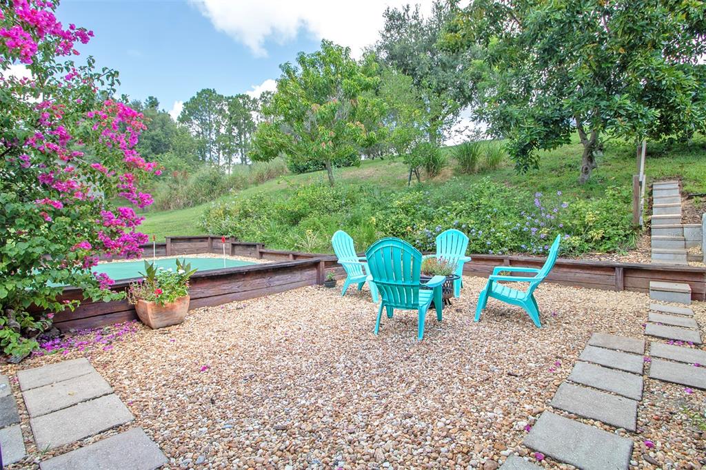 1111 Spruce Ridge Court Minneola, FL 34715 - Photo 27 of 34 a view of a chairs and table in the garden