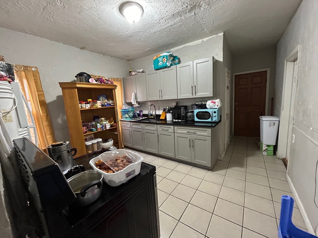 7 Bluff Street Worcester, MA 01610 - Photo 5 of 11 a kitchen with a sink a stove and refrigerator