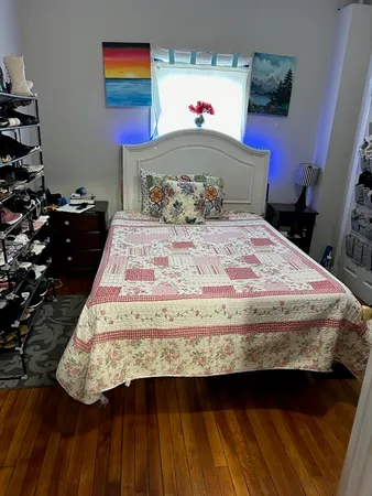 a bedroom with a bed and a window