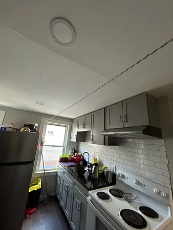 a kitchen with a sink stove and cabinets