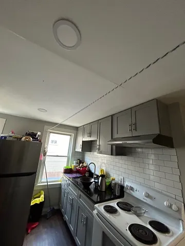a kitchen with a sink stove and cabinets
