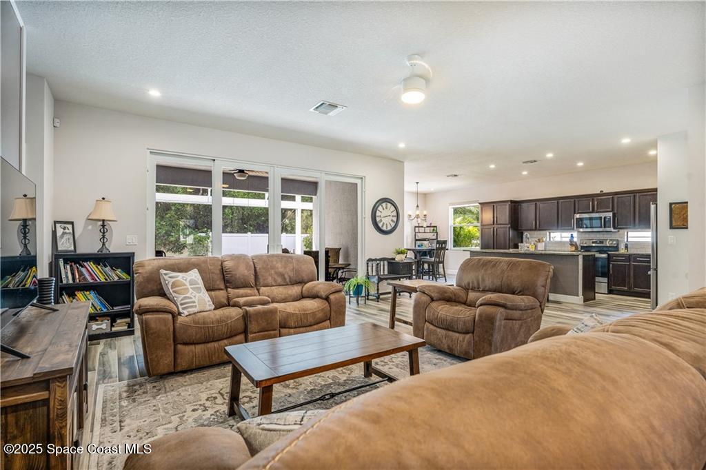 Undisclosed Address Vero Beach, FL 32966 - Photo 12 of 36 a living room with furniture kitchen view and large windows