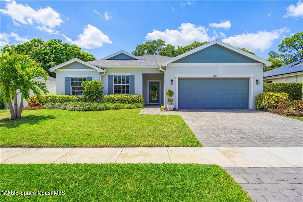 Undisclosed Address Vero Beach, FL 32966 - Photo 2 of 36 a front view of a house with a yard and garage