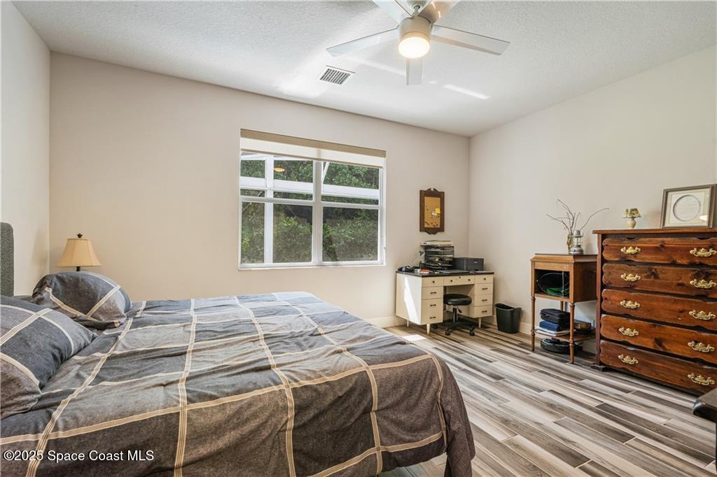 Undisclosed Address Vero Beach, FL 32966 - Photo 28 of 36 a bedroom with a bed and wooden floor