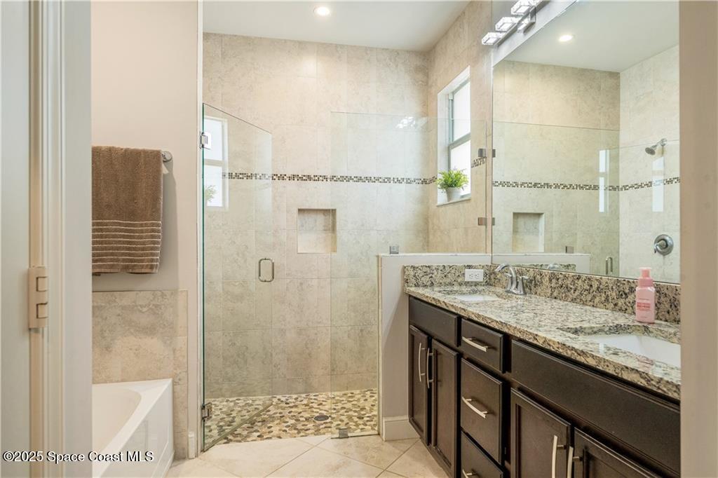 Undisclosed Address Vero Beach, FL 32966 - Photo 30 of 36 a bathroom with a granite countertop sink a mirror and shower