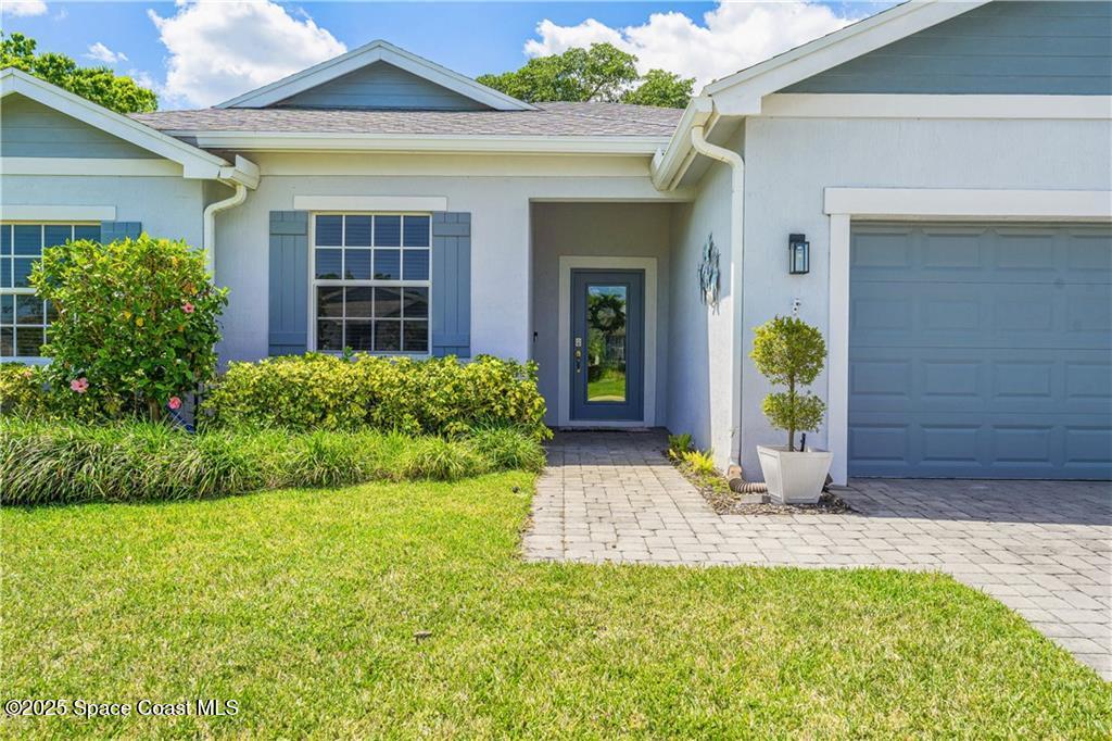 Undisclosed Address Vero Beach, FL 32966 - Photo 36 of 36 a view of a house with potted plants and a table and chairs