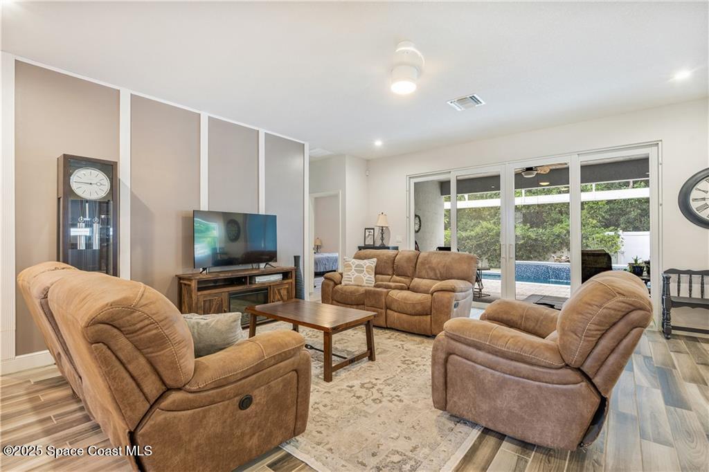 Undisclosed Address Vero Beach, FL 32966 - Photo 6 of 36 a living room with furniture a large window and a flat screen tv