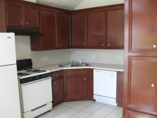 a kitchen with a cabinets and white stove