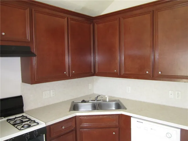 a kitchen with cabinets and window