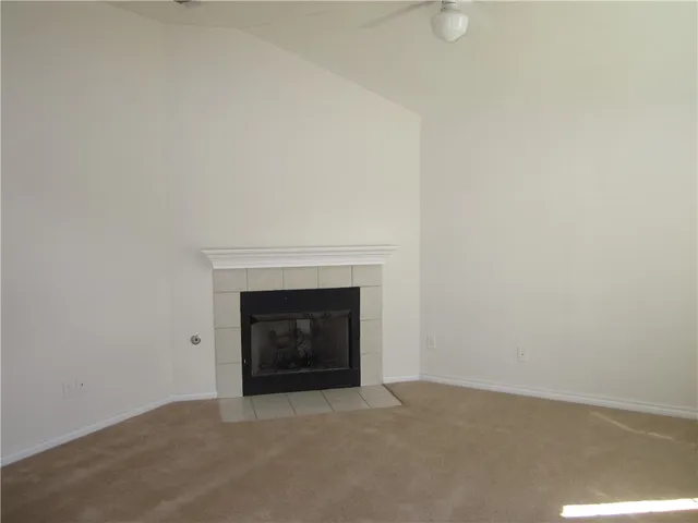 a view of an empty room with a fireplace