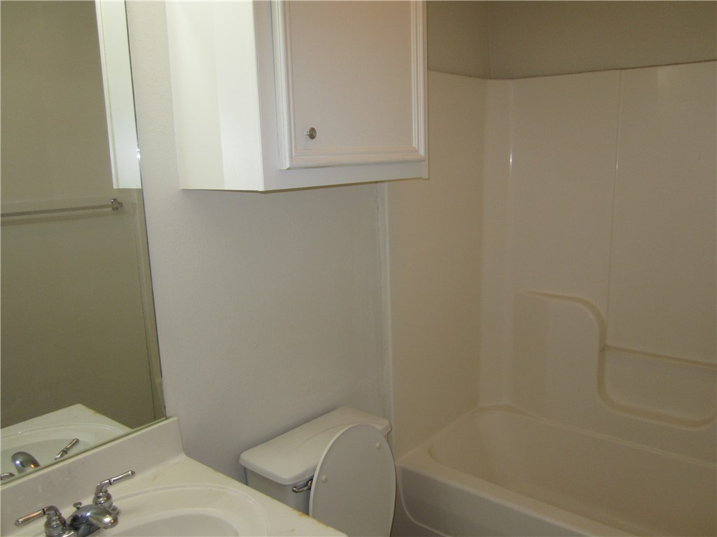 306 Fairway Drive, Unit A Bryan, TX 77801 - Photo 5 of 11 a bathroom with a toilet and bathtub