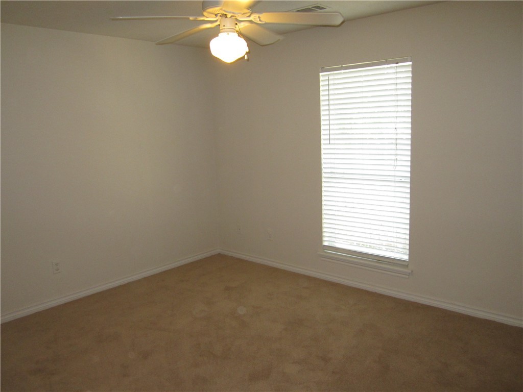 306 Fairway Drive, Unit A Bryan, TX 77801 - Photo 7 of 11 an empty room with a window
