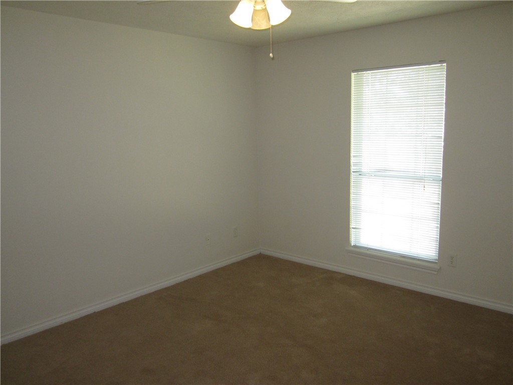 306 Fairway Drive, Unit A Bryan, TX 77801 - Photo 8 of 11 an empty room with a window