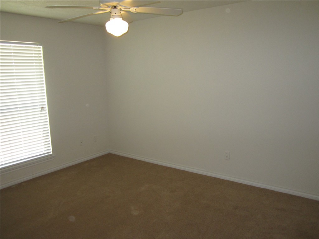 306 Fairway Drive, Unit A Bryan, TX 77801 - Photo 9 of 11 an empty room with a window