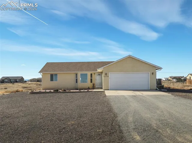 a big house with a yard and garage