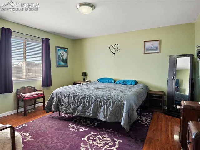 a bedroom with a bed chair and a window