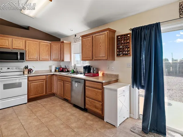 a kitchen with stainless steel appliances granite countertop a refrigerator sink and cabinets