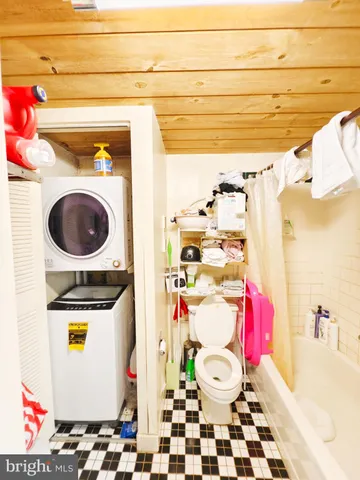 a bathroom with a sink a toilet and curtain