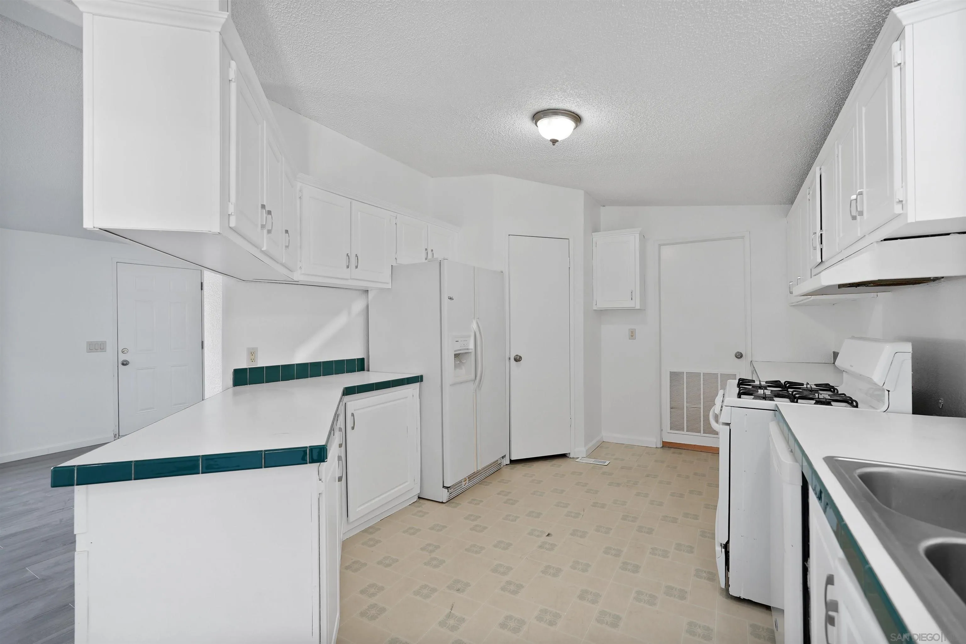 1455 Alturas Road, Unit SPC 18 Fallbrook, CA 92028 - Photo 20 of 50 a kitchen with stainless steel appliances a refrigerator sink and white cabinets