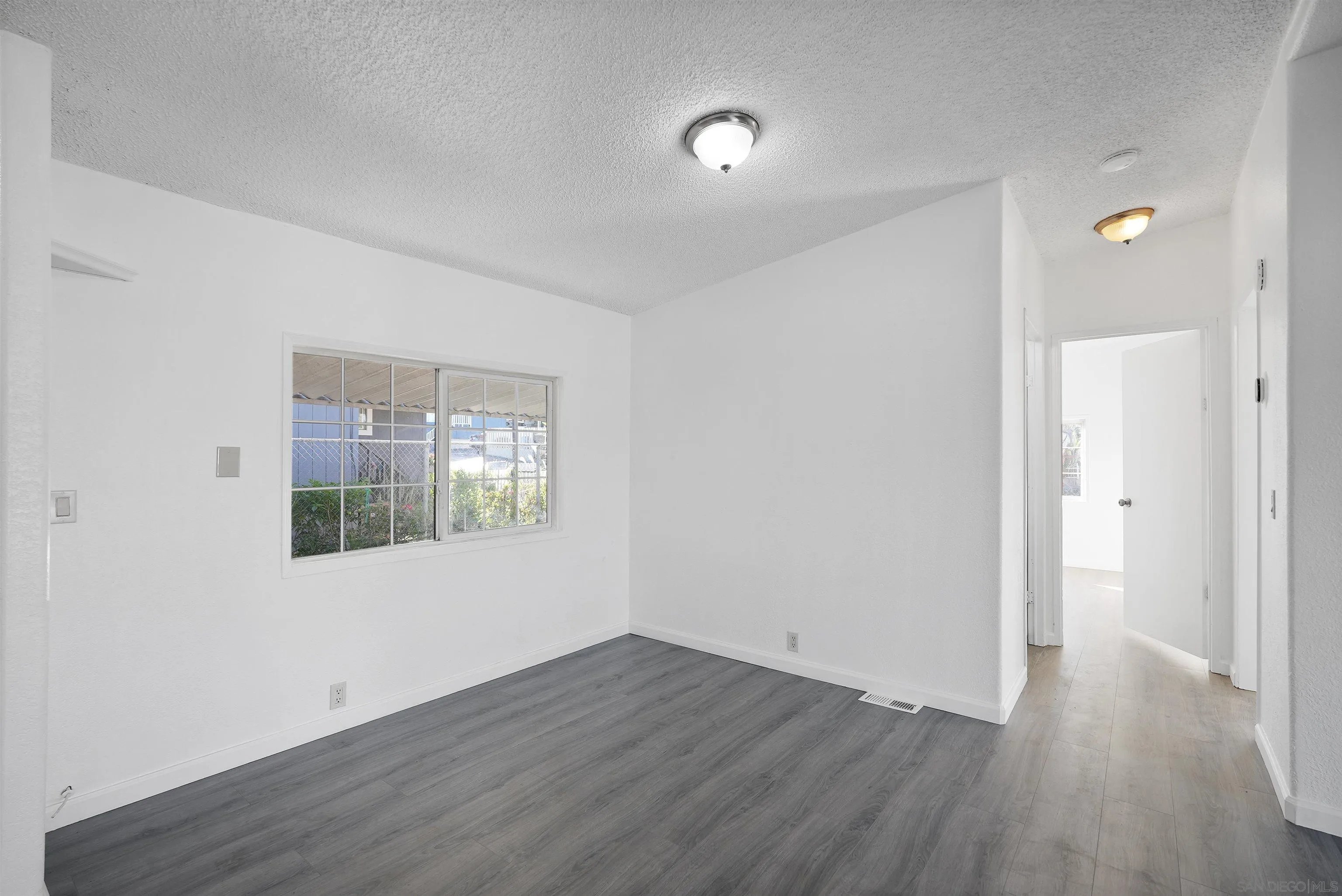 1455 Alturas Road, Unit SPC 18 Fallbrook, CA 92028 - Photo 5 of 50 an empty room with wooden floor and windows