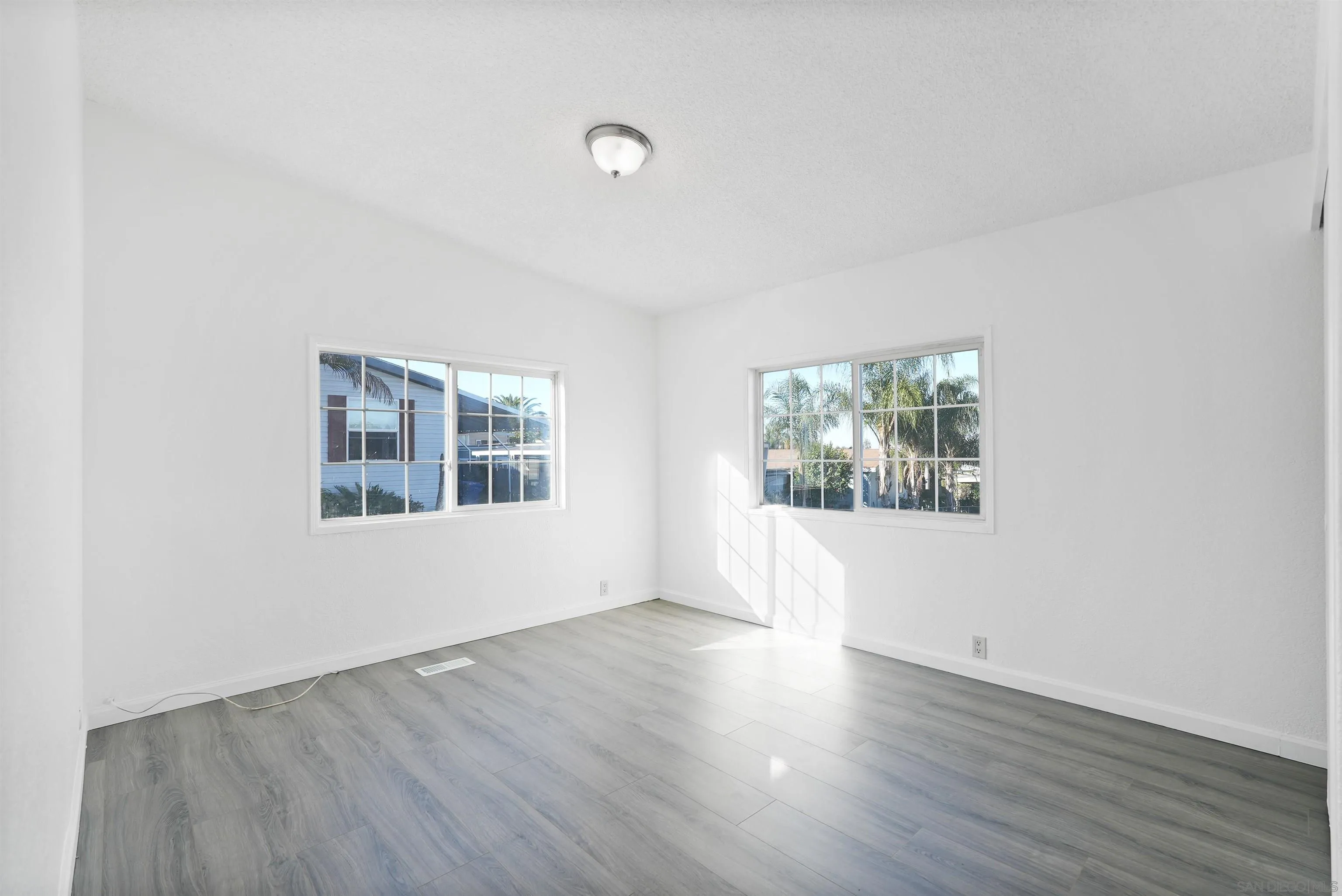 1455 Alturas Road, Unit SPC 18 Fallbrook, CA 92028 - Photo 6 of 50 a view of an empty room with wooden floor and a window