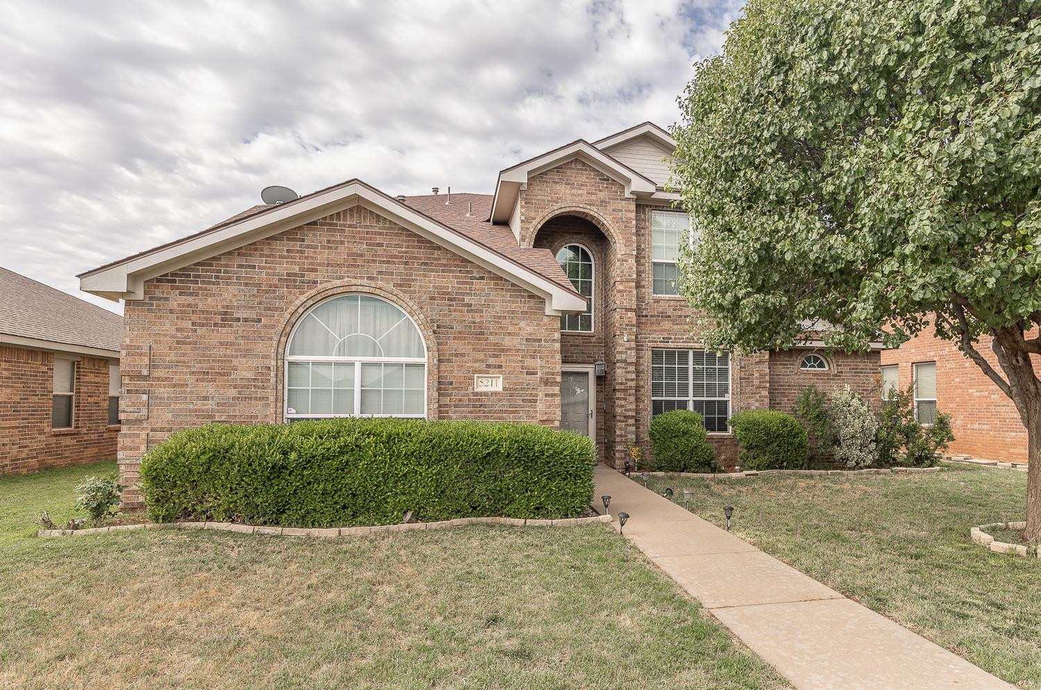 5211 Harvard Street Lubbock, TX 79416 - Photo 1 of 31 a front view of a house with garden