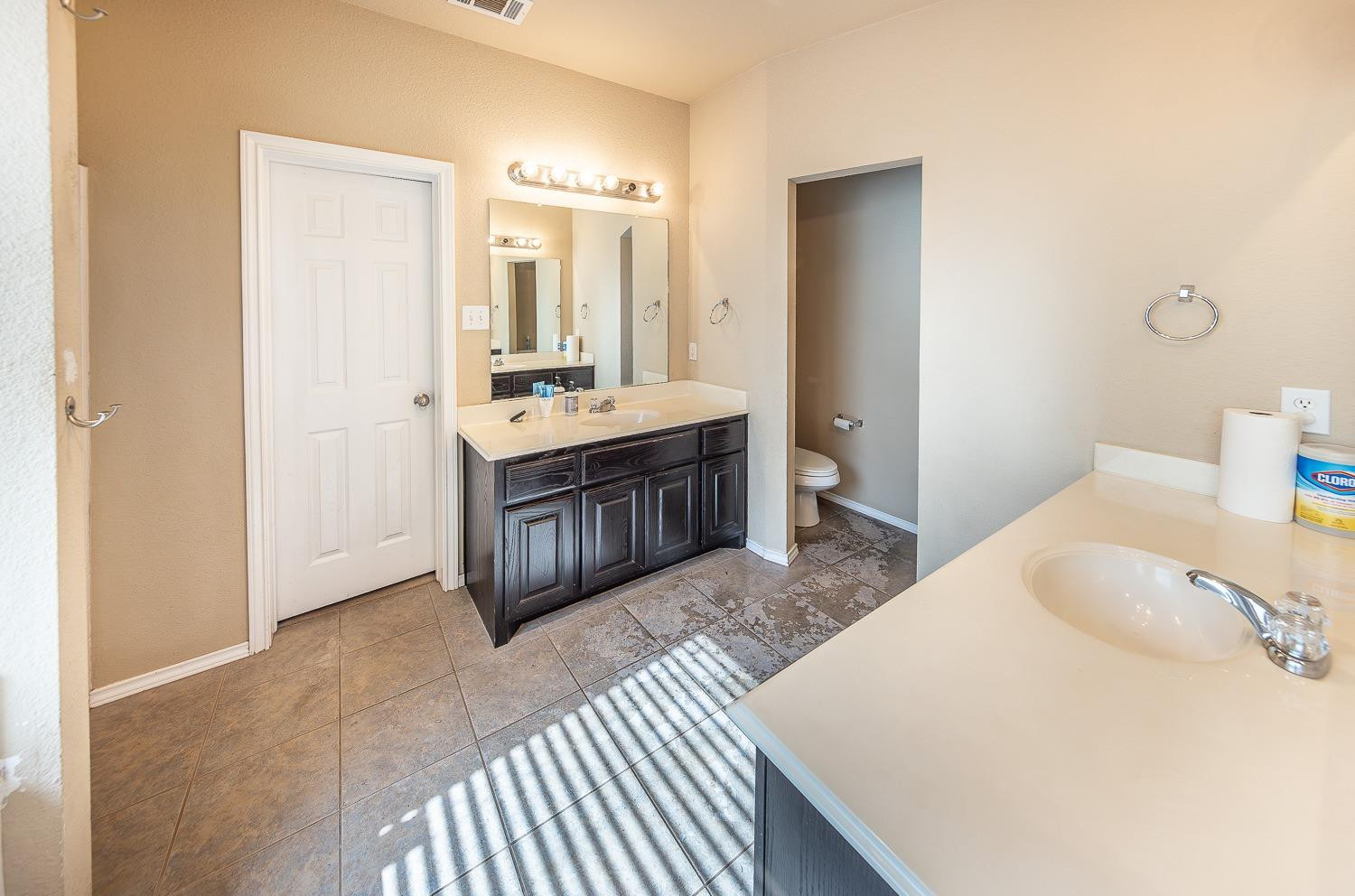 5211 Harvard Street Lubbock, TX 79416 - Photo 15 of 31 a spacious bathroom with a tub sink and mirror