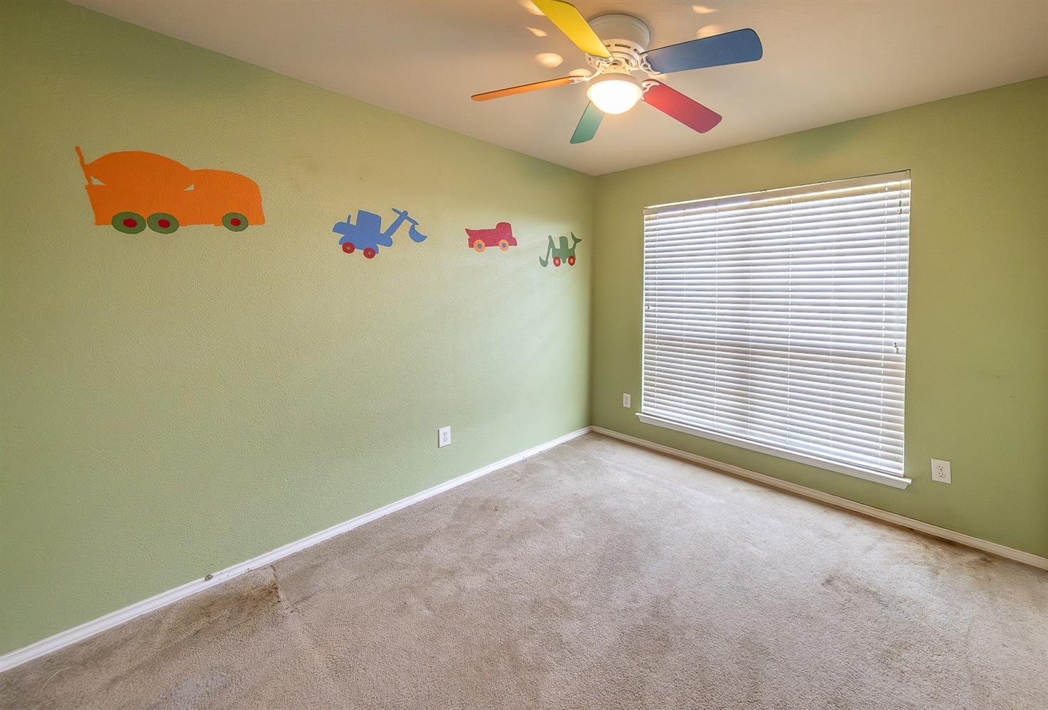 5211 Harvard Street Lubbock, TX 79416 - Photo 17 of 31 an empty room with windows and fan