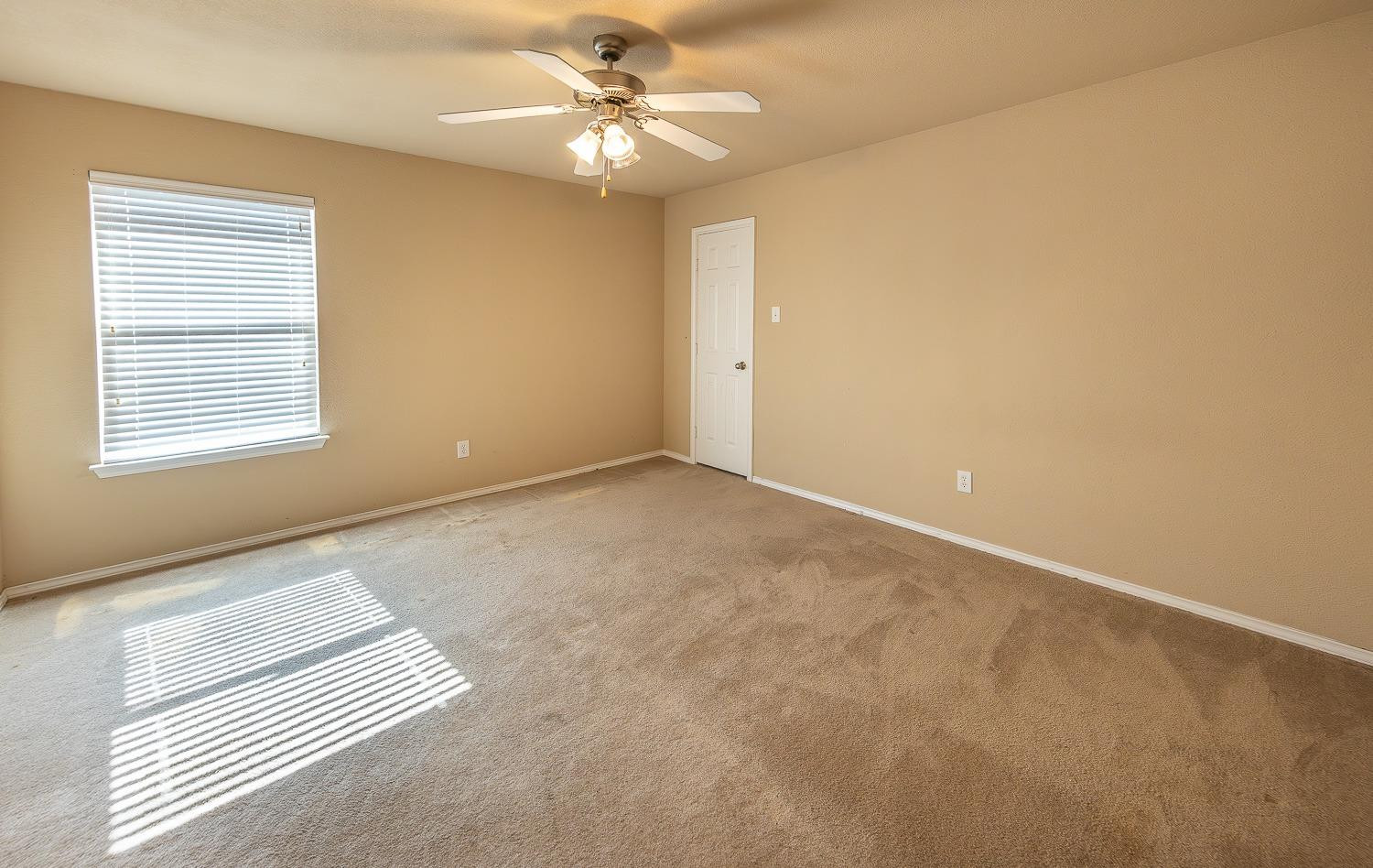 5211 Harvard Street Lubbock, TX 79416 - Photo 23 of 31 an empty room with windows and fan