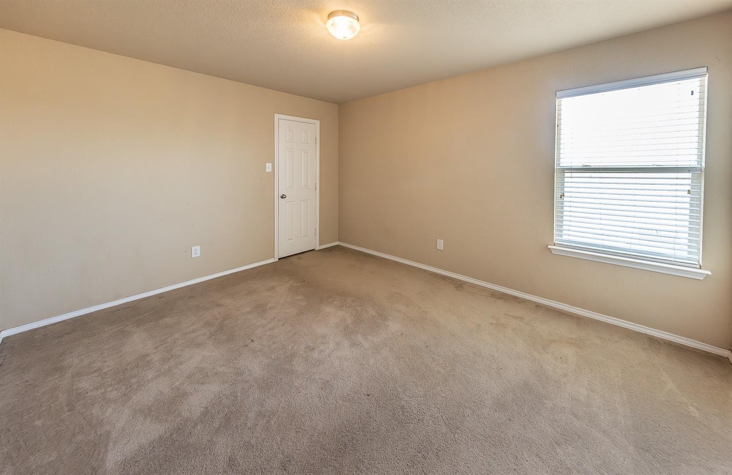 5211 Harvard Street Lubbock, TX 79416 - Photo 25 of 31 an empty room with a window