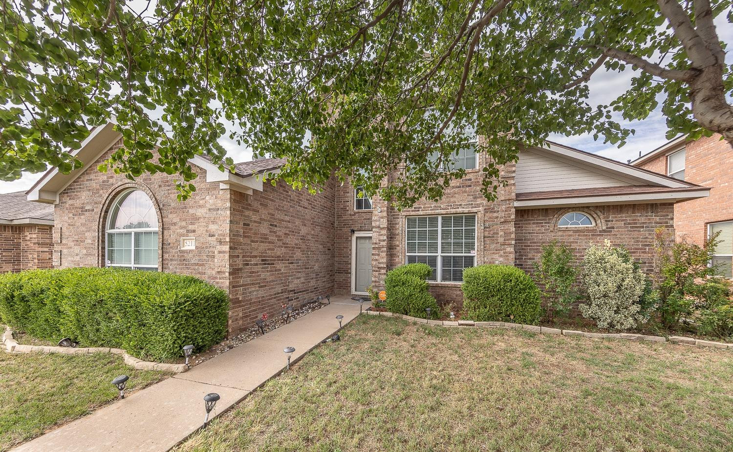 5211 Harvard Street Lubbock, TX 79416 - Photo 31 of 31 a front view of a house with garden