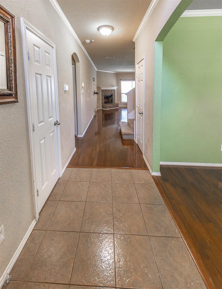 5211 Harvard Street Lubbock, TX 79416 - Photo 4 of 31 a hallway with a washer and dryer