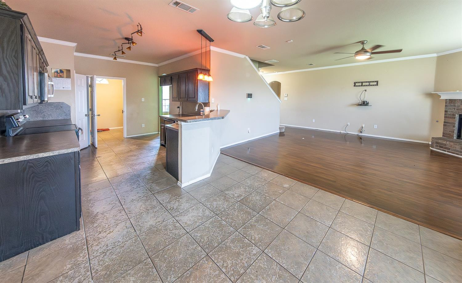 5211 Harvard Street Lubbock, TX 79416 - Photo 8 of 31 a view of a kitchen with furniture and wooden floor