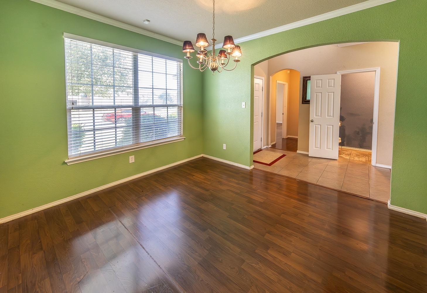 5211 Harvard Street Lubbock, TX 79416 - Photo 10 of 31 a view of a room with window and wooden floor