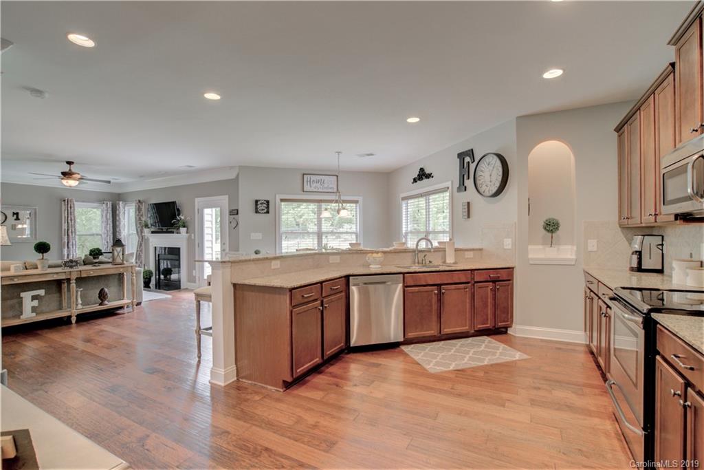 1200 Ridgehaven Road Waxhaw, NC 28173 - Photo 11 of 47 a large kitchen with stainless steel appliances granite countertop a lot of counter space and wooden floors