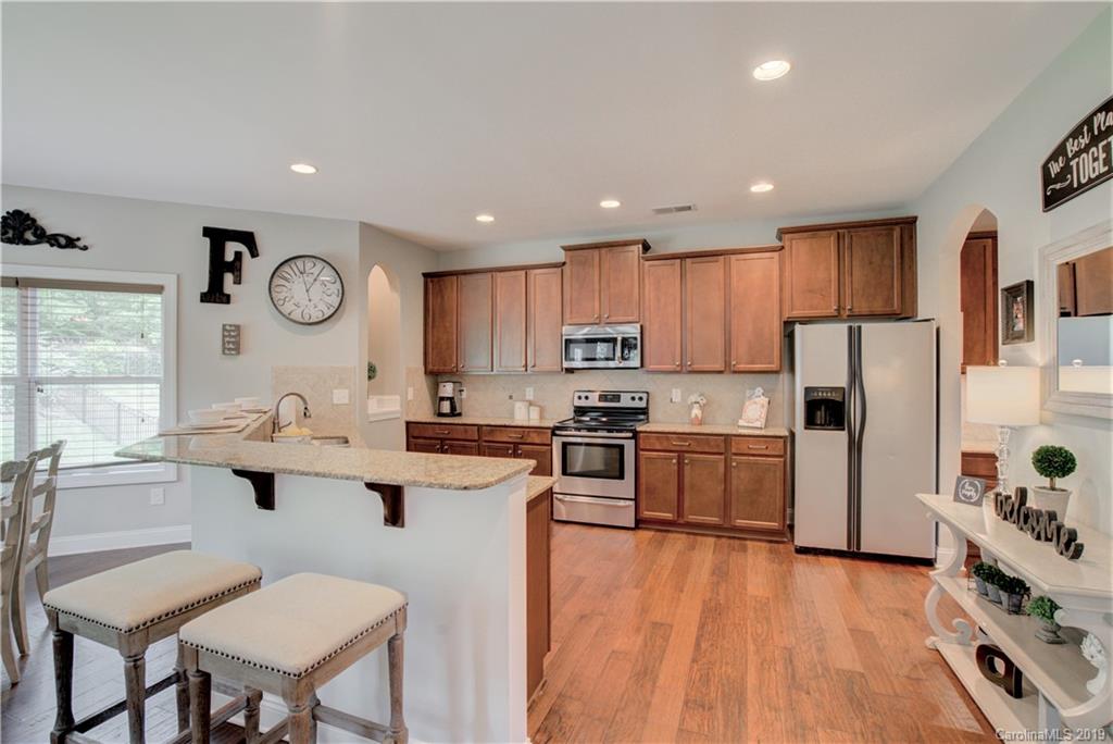 1200 Ridgehaven Road Waxhaw, NC 28173 - Photo 12 of 47 a kitchen with a sink a counter top space stainless steel appliances cabinets and a window