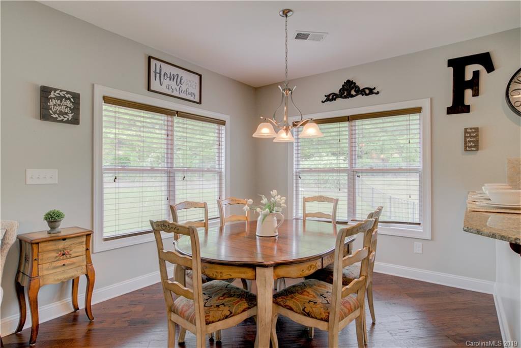 1200 Ridgehaven Road Waxhaw, NC 28173 - Photo 15 of 47 a view of a dining room with furniture window and wooden floor