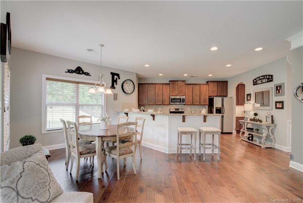 1200 Ridgehaven Road Waxhaw, NC 28173 - Photo 16 of 47 a view of a dining room with furniture and wooden floor