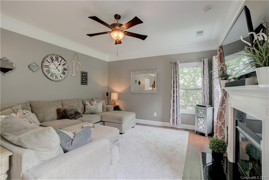 1200 Ridgehaven Road Waxhaw, NC 28173 - Photo 20 of 47 a living room with furniture a fireplace and a flat screen tv