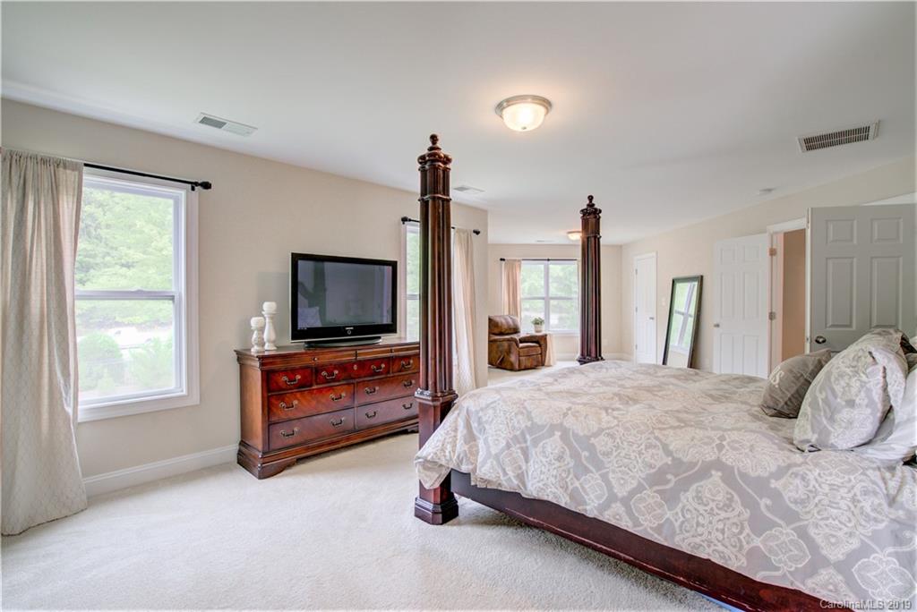 1200 Ridgehaven Road Waxhaw, NC 28173 - Photo 24 of 47 a bedroom with a bed and a flat screen tv