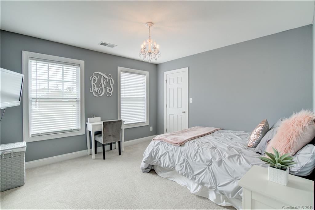1200 Ridgehaven Road Waxhaw, NC 28173 - Photo 29 of 47 a bedroom with a bed table chair and a window
