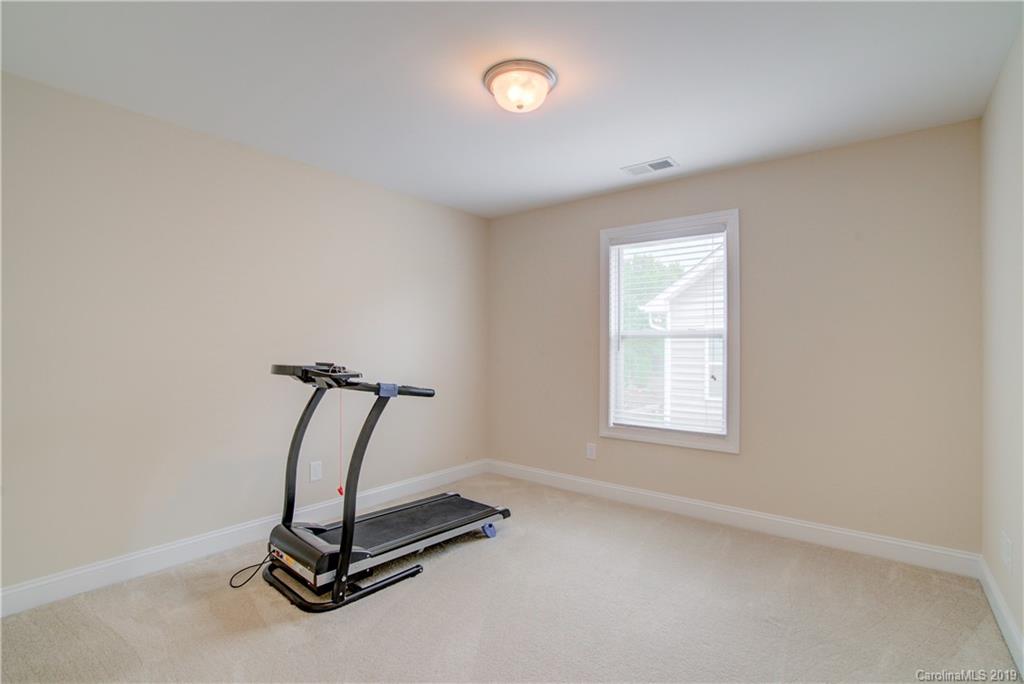 1200 Ridgehaven Road Waxhaw, NC 28173 - Photo 32 of 47 a room with gym equipment and windows