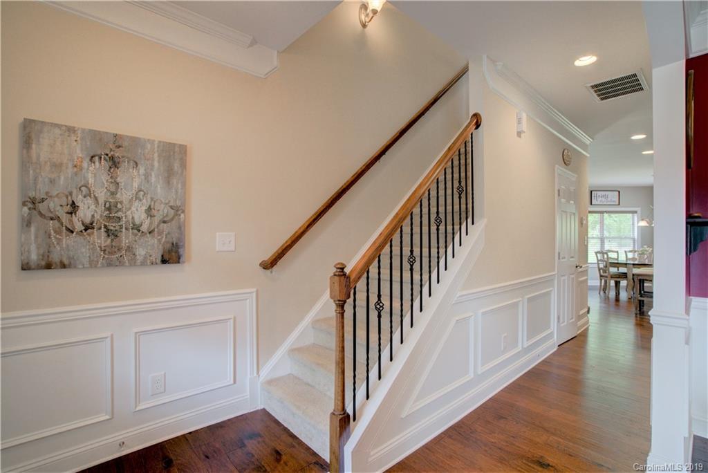 1200 Ridgehaven Road Waxhaw, NC 28173 - Photo 6 of 47 a view of staircase with white walls and wooden floor
