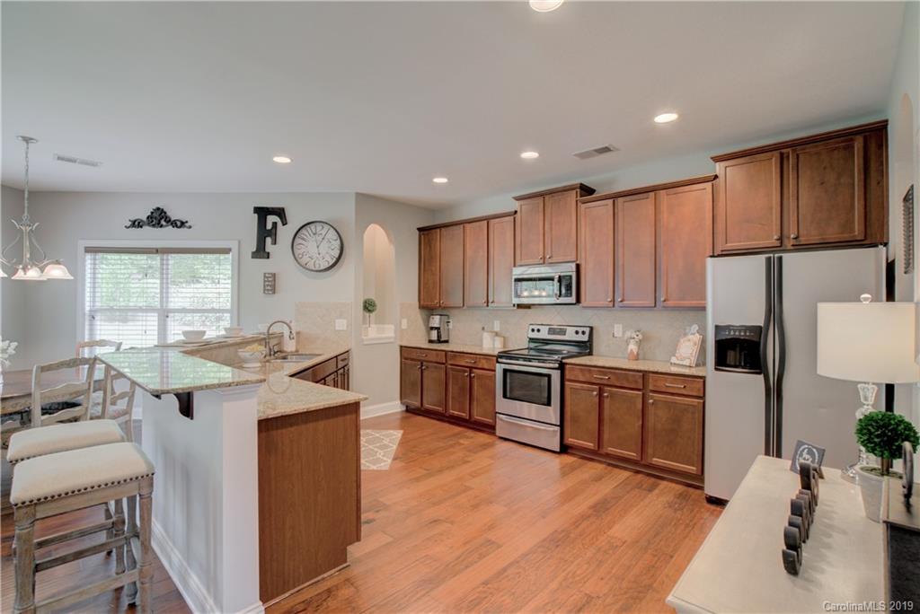 1200 Ridgehaven Road Waxhaw, NC 28173 - Photo 9 of 47 a large kitchen with stainless steel appliances granite countertop a stove a sink dishwasher and a refrigerator