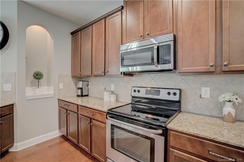 1200 Ridgehaven Road Waxhaw, NC 28173 - Photo 10 of 47 a kitchen with stainless steel appliances granite countertop a stove a microwave and a sink